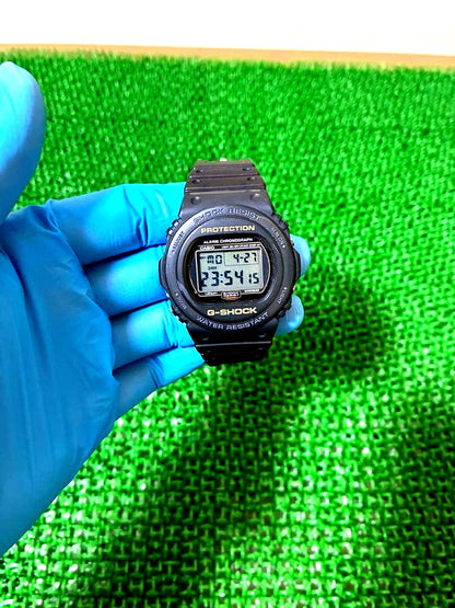 Casio G-Shock DW-5700 used watch showing front face with visible scratches