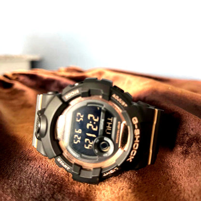 Casio G-Shock GMD-B800 digital watch in black and gold with digital display and shock resistance