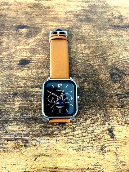 Casio digital watch with square face and black and brown leather strap