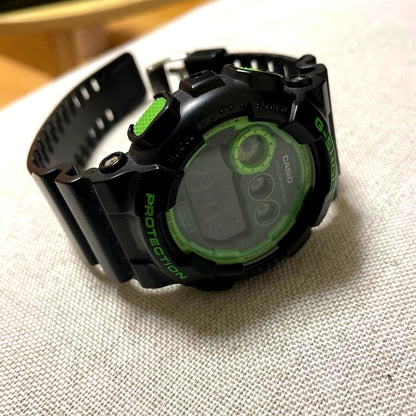 Casio G-Shock GD-120N digital wristwatch in black and green with illuminator and water-resistant features