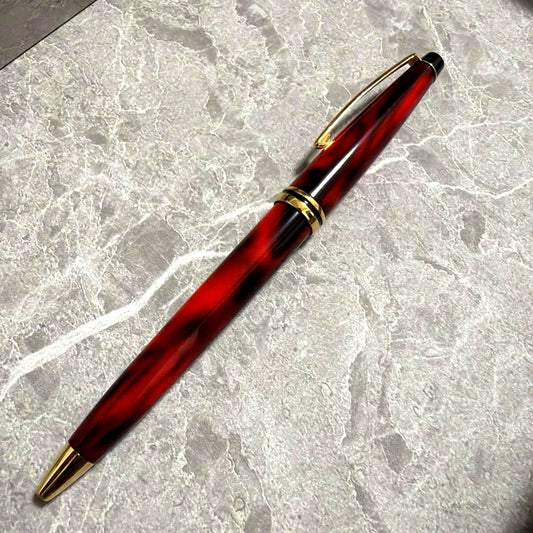 Cross Vintage ballpoint pen with dark red marbled barrel and gold accents, approximately 5.5 inches long
