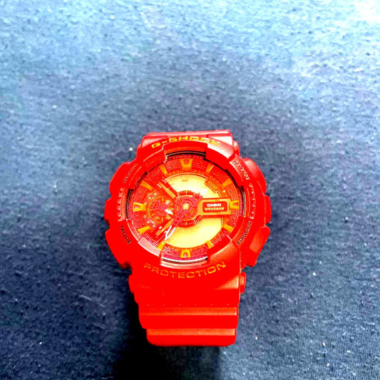 Casio G-Shock red watch with shock resistance, water resistance, red resin case, and stainless steel buckle