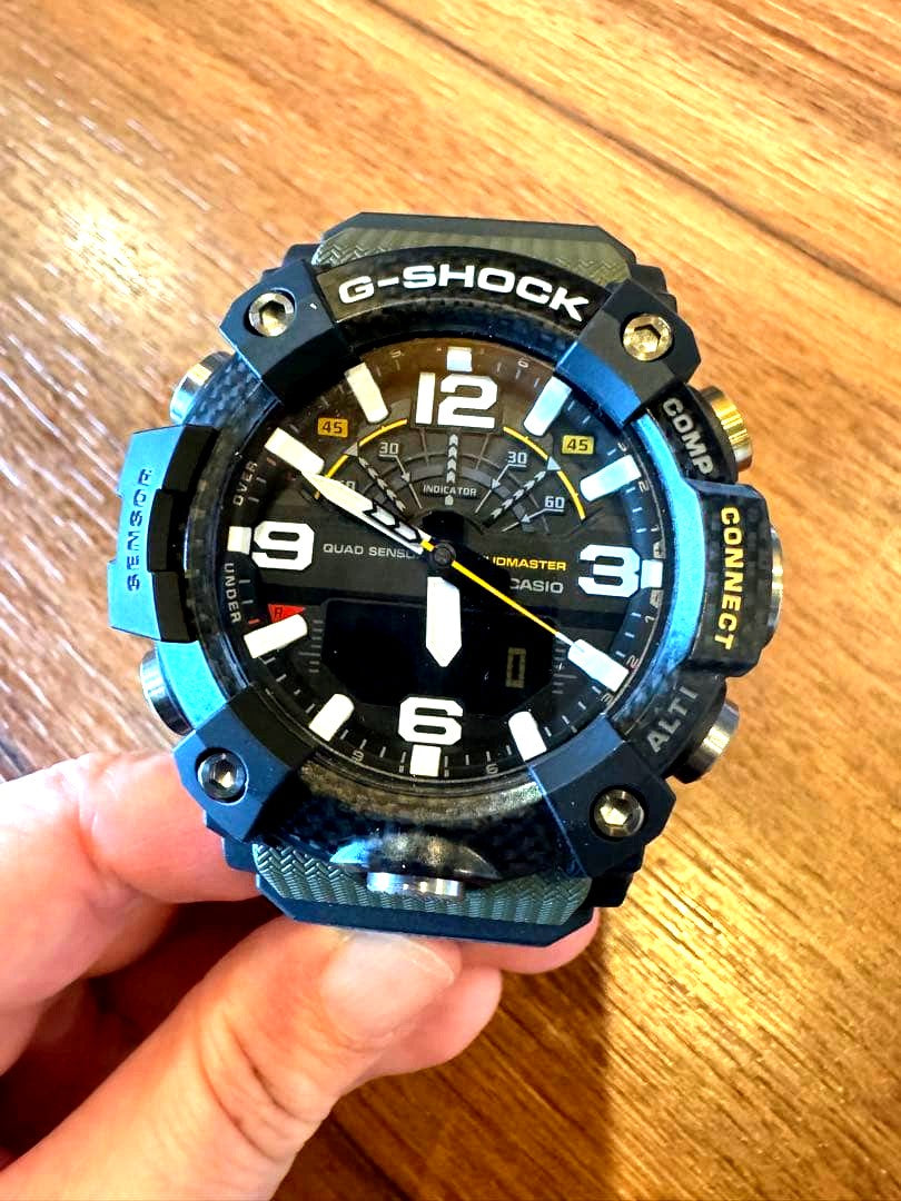 Casio G-Shock Mudmaster GGB100-1A3JF wristwatch with black and green accents, shown with damaged box
