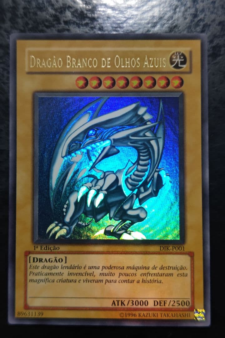Portuguese Blue-Eyes White Dragon Ultra Rare Yu-Gi-Oh! card with minor scratches on front and back