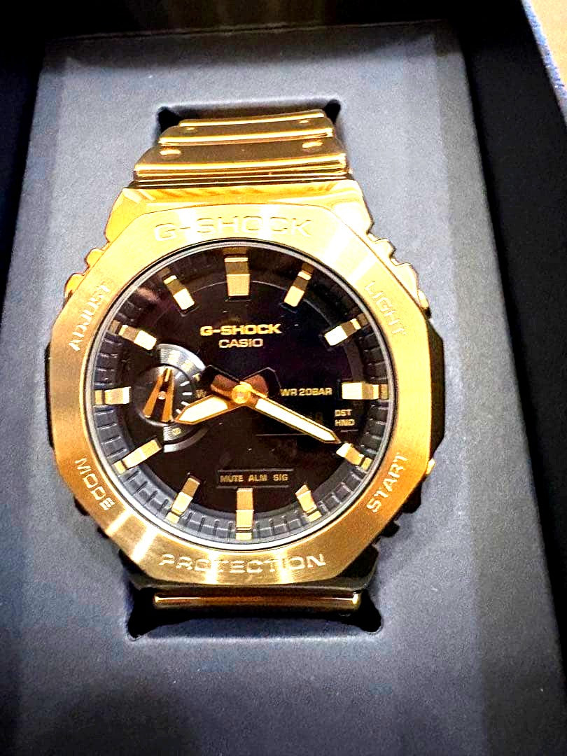 Casio G-Shock GM-2100YMG-9AJF gold watch with metallic finish and digital-analog display