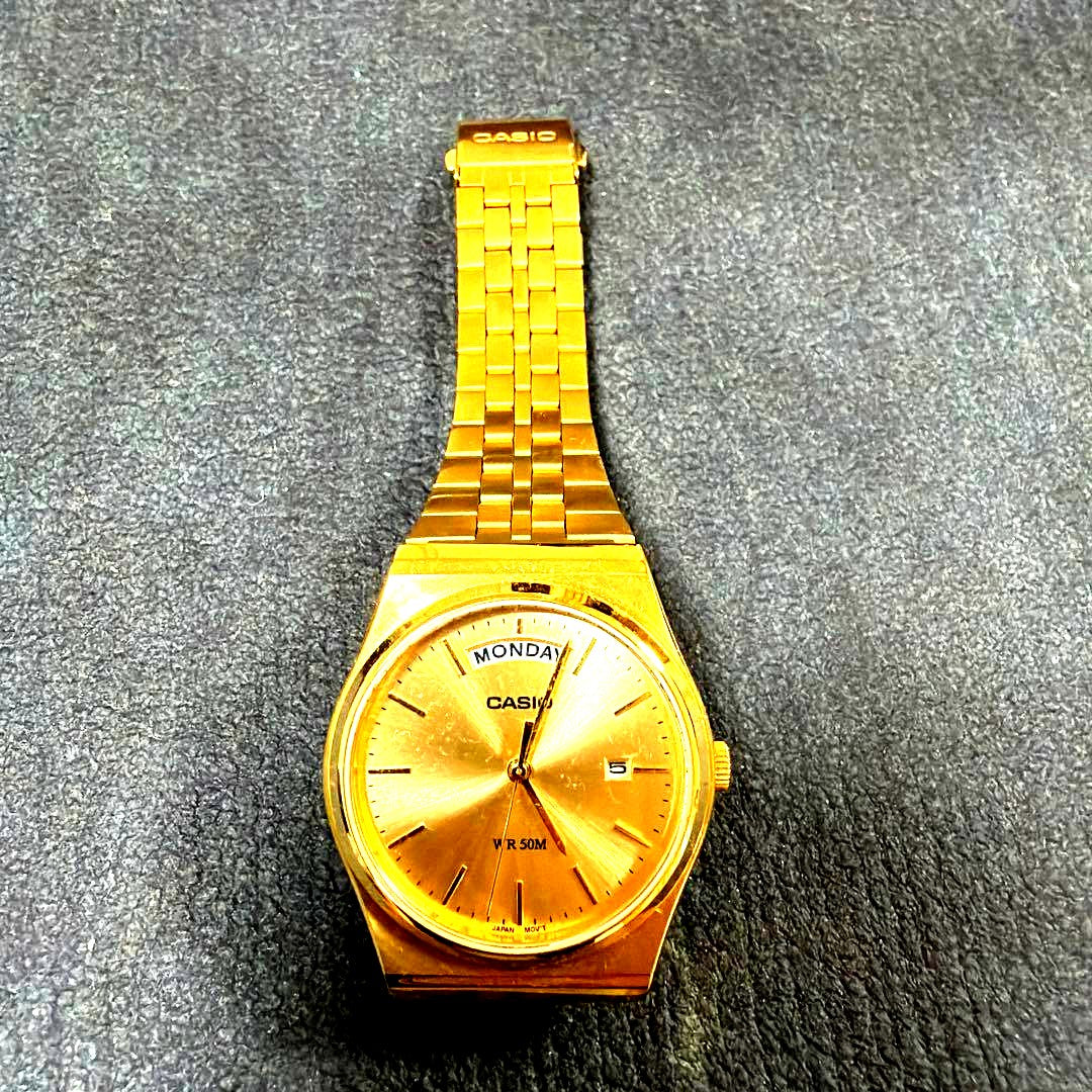 Casio MTP-B146G-9AV gold quartz wristwatch with date display, Japan import, photographed on white background