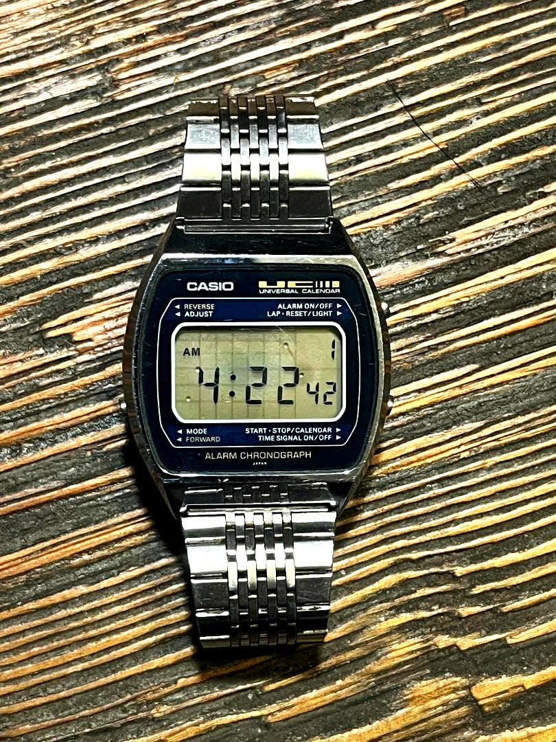 Casio 79QS-39 UC vintage digital watch showing scratches on glass and digital face with retro design