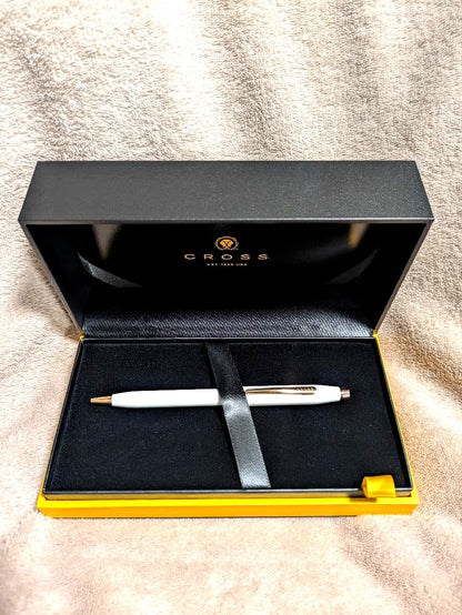 Cross white ballpoint pen with gold accents displayed alongside a gift box and two black medium tip refills