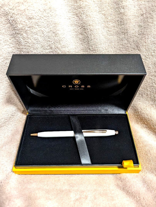 Cross white ballpoint pen with gold accents displayed alongside a gift box and two black medium tip refills