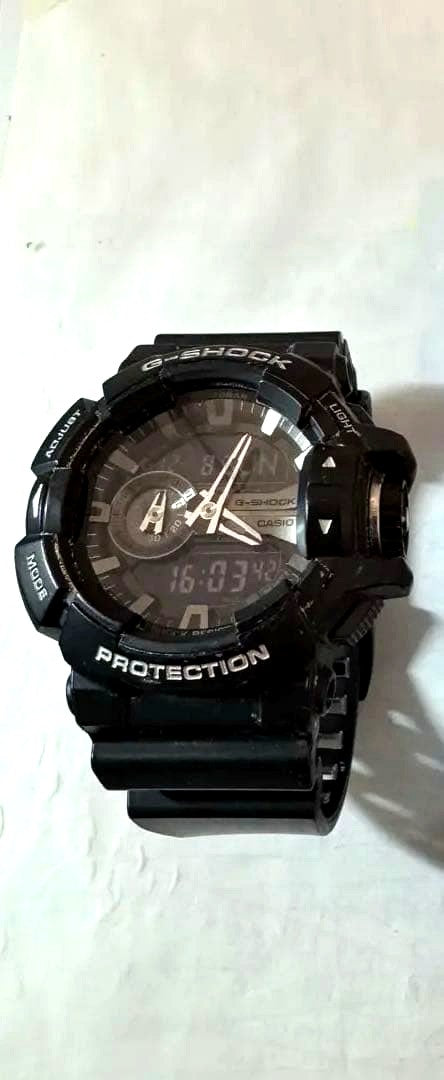Casio G-Shock GA-400GB digital watch with black band showing signs of wear and scratches
