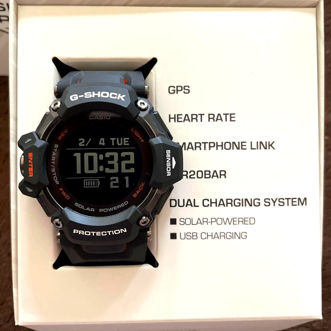 Casio G-Shock GBD-H2000 black and orange watch with GPS and heart rate monitor shown with accessories
