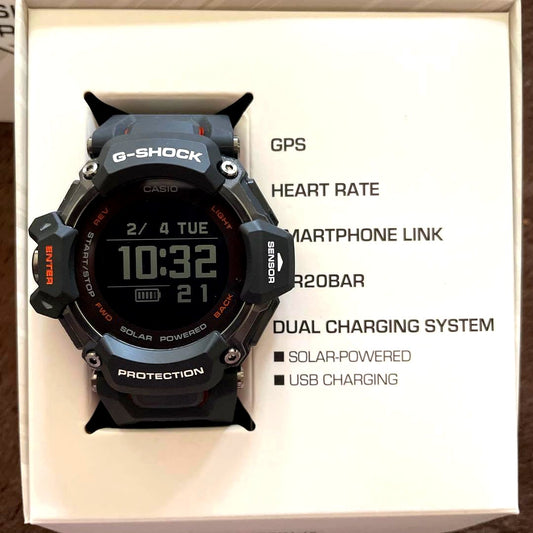 Casio G-Shock GBD-H2000 black and orange watch with GPS and heart rate monitor shown with accessories