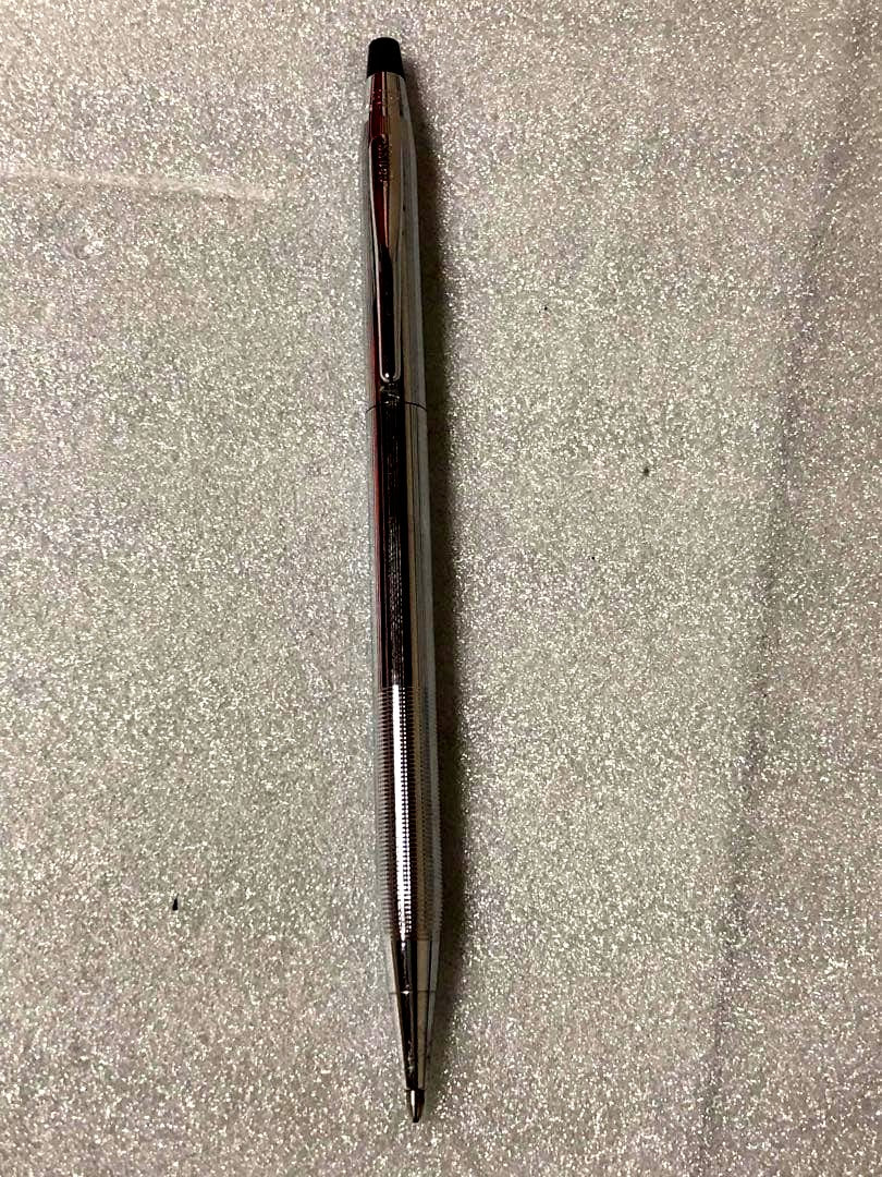 Cross brand sleek black pen with silver accents on a white background