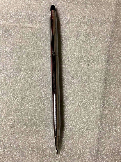 Cross brand sleek black pen with silver accents on a white background