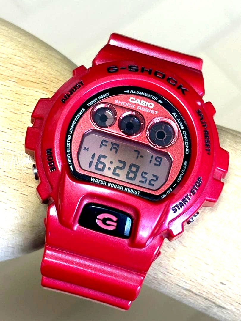 Casio G-Shock DW-6900MF vintage watch with red metallic dial and three-eyed design, used condition
