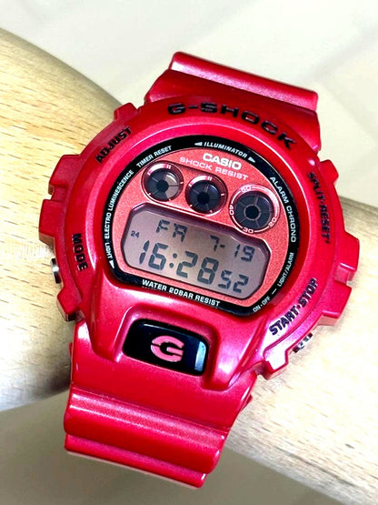 Casio G-Shock DW-6900MF vintage watch with red metallic dial and three-eyed design, used condition