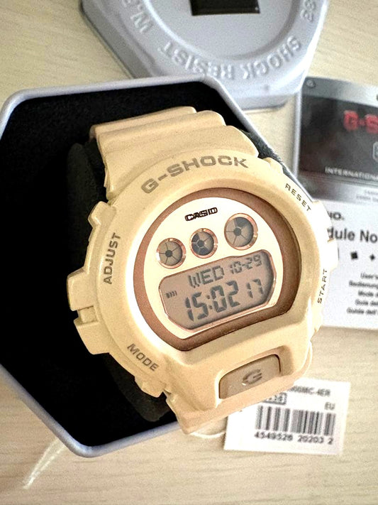 Casio G-Shock GMD-S6900MC-4ER watch in pink beige and gold with digital display and black strap