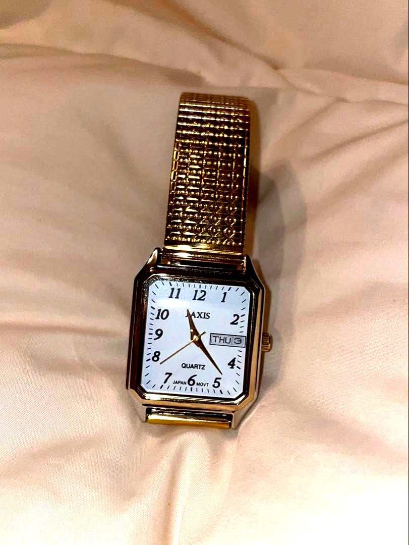 Casio Quartz Watch with gold and silver square face and stretch band showing day and date display