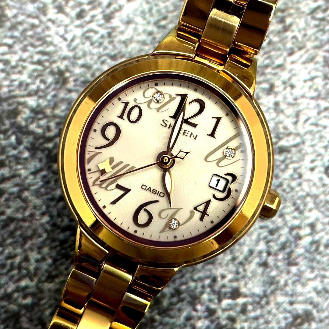 Casio Sheen ladies watch with gold round dial, linen stones, and gold-tone stainless steel band
