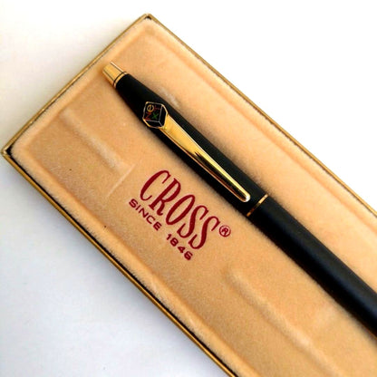 Cross black ballpoint pen with NEXT logo clip, blue ink, black body, displayed with case and instruction manual