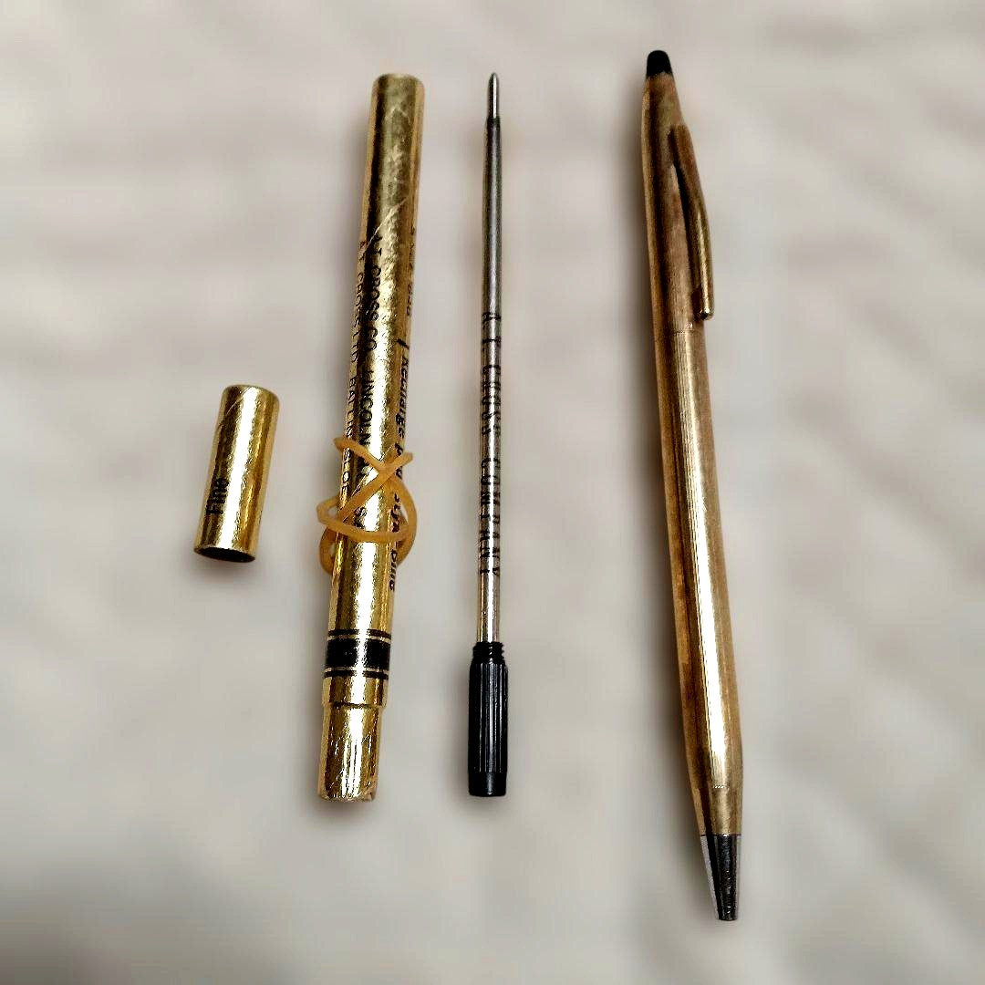 Gold-colored ballpoint pen with replacement ink cartridge, Japanese import, brand unknown
