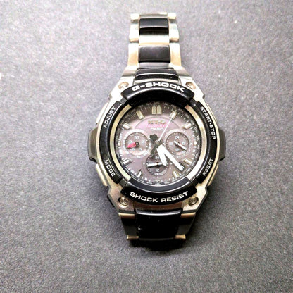 Casio G-Shock MTG-1200-1AJF watch with black dial and metal case showing minor wear and scratches
