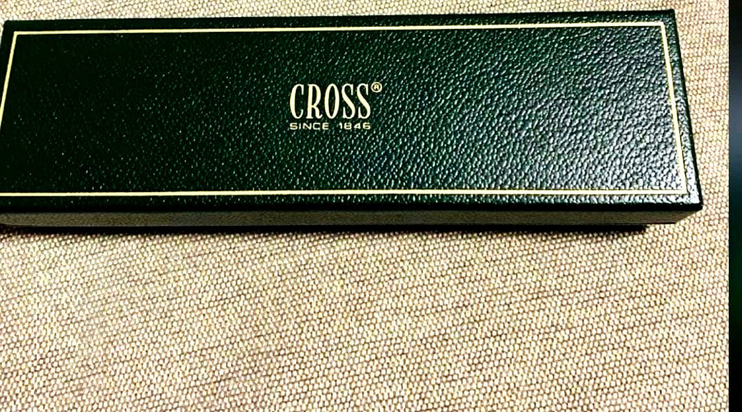 Cross silver ballpoint pen displayed with its dedicated case on a white background