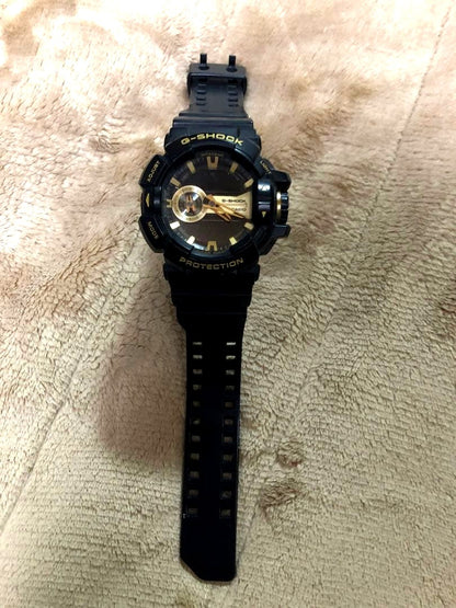 Casio G-Shock GA-400GB-1A9 used watch with black and gold design showing some wear and scratches