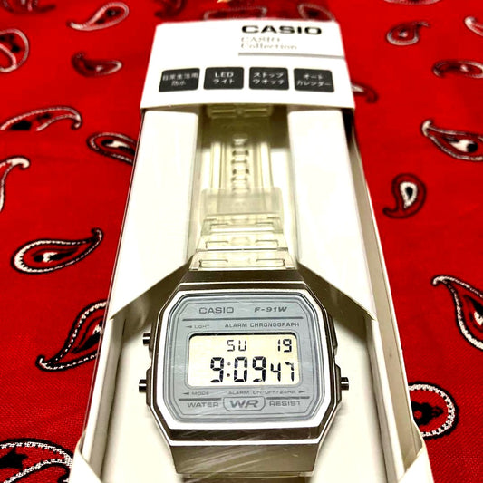 Casio F-91W digital watch in clear plastic case and band with a black digital display