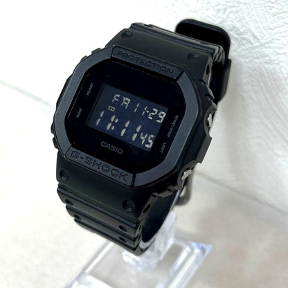 Casio G-Shock DW-5600BB black digital watch showing time and features on display