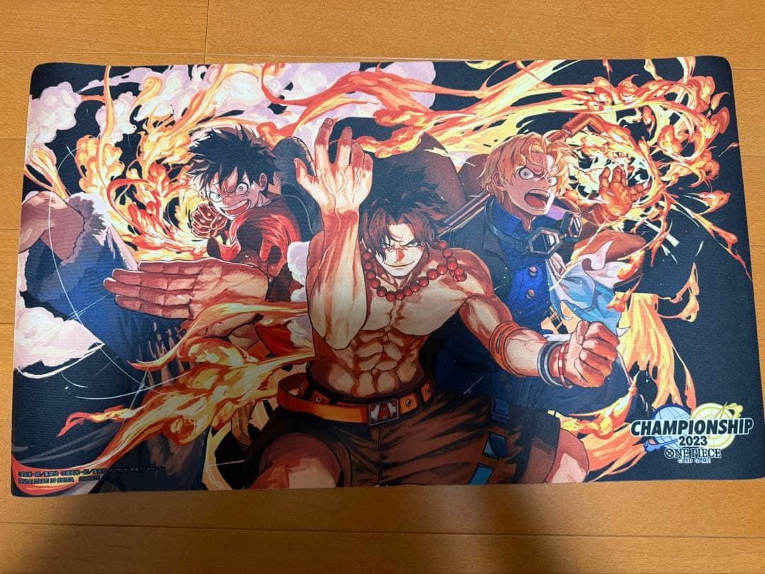 Official One Piece Championship2023 playmat featuring Luffy Ace and Sabo characters