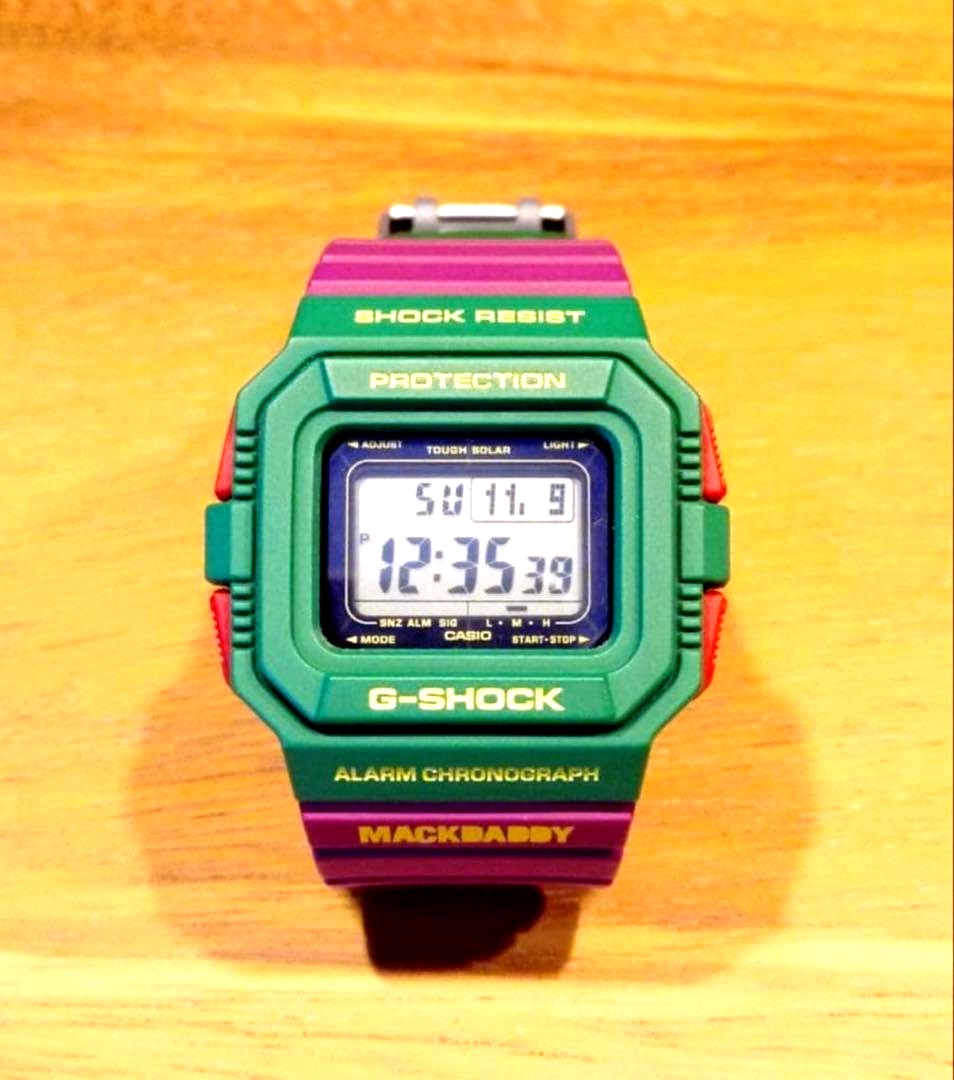 Casio G-Shock MACKDADDY colorful watch featuring green, purple, and red colors with alarm and chronograph functions