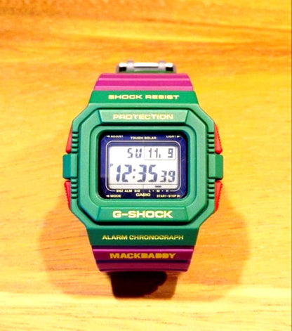 Casio G-Shock MACKDADDY colorful watch featuring green, purple, and red colors with alarm and chronograph functions