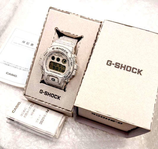 Casio G-Shock DW-6900RGM-5JR men's origami design watch with black and red accents, showing the face and band