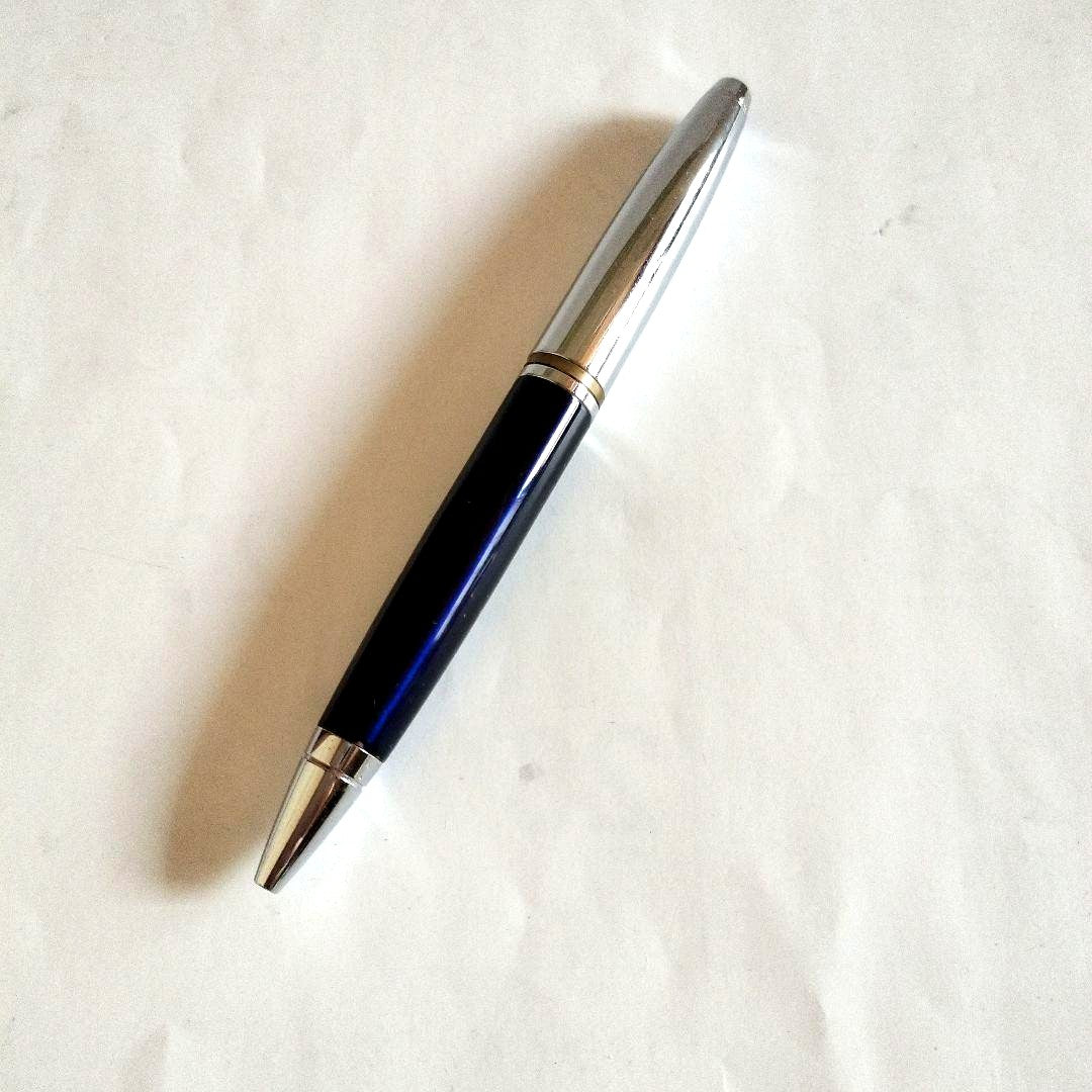 Sigma Cross ballpoint pen Japan import showing black ink with signs of use including small scratches and paint peeling