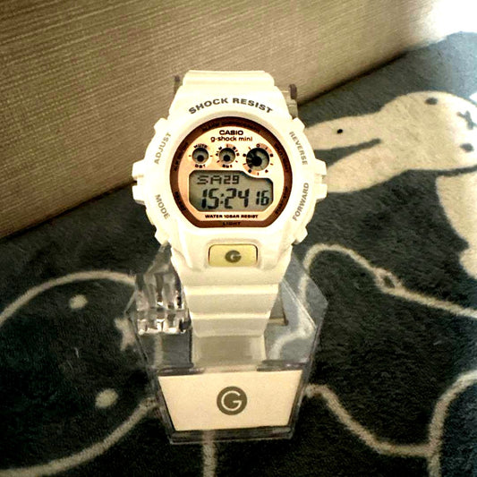 Casio G-Shock Mini wristwatch in original box with minor dirt, front view showing digital display