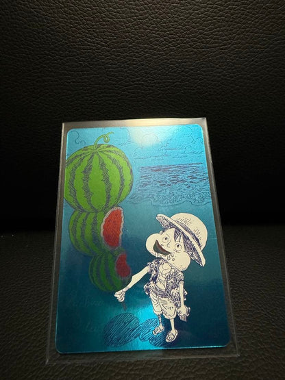 One Piece Natsucomi 2026 Metakira card featuring Monkey D. Luffy signed by Eiichiro Oda in protective sleeve