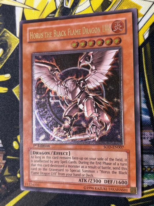 Yugioh Horus the Black Flame Dragon LV6 English 1st Edition relief card with visible wear and scratches