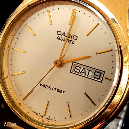 Casio MQ-514 gold men’s wristwatch showing date and day with gold case and brown strap