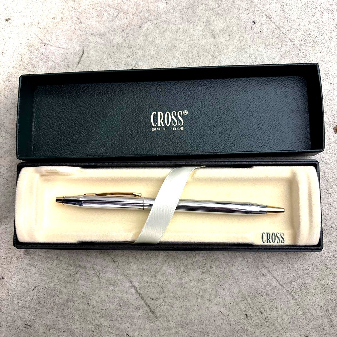 Cross ballpoint pen in silver and gold with slim design and twist mechanism, shown with dedicated case