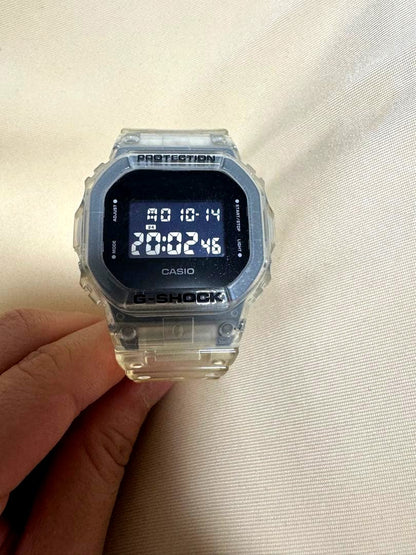 Casio G-Shock digital watch with clear case and band showing time and date display