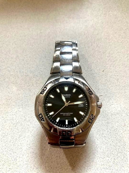 Casio wristwatch model MTD-1044 with black round dial and silver stainless steel band