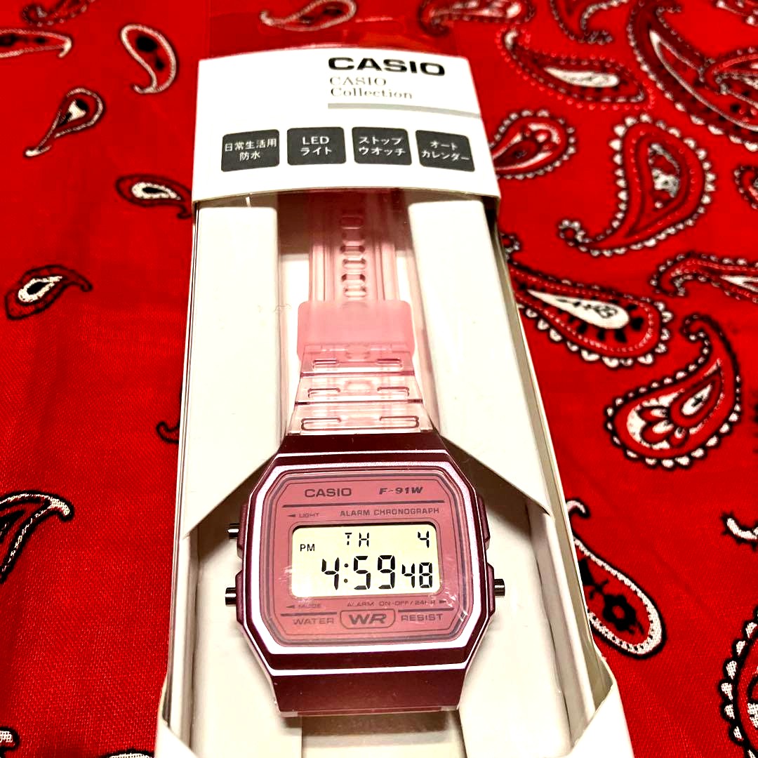 Casio F-91W clear pink digital watch in original packaging with minor box scratches Japan import