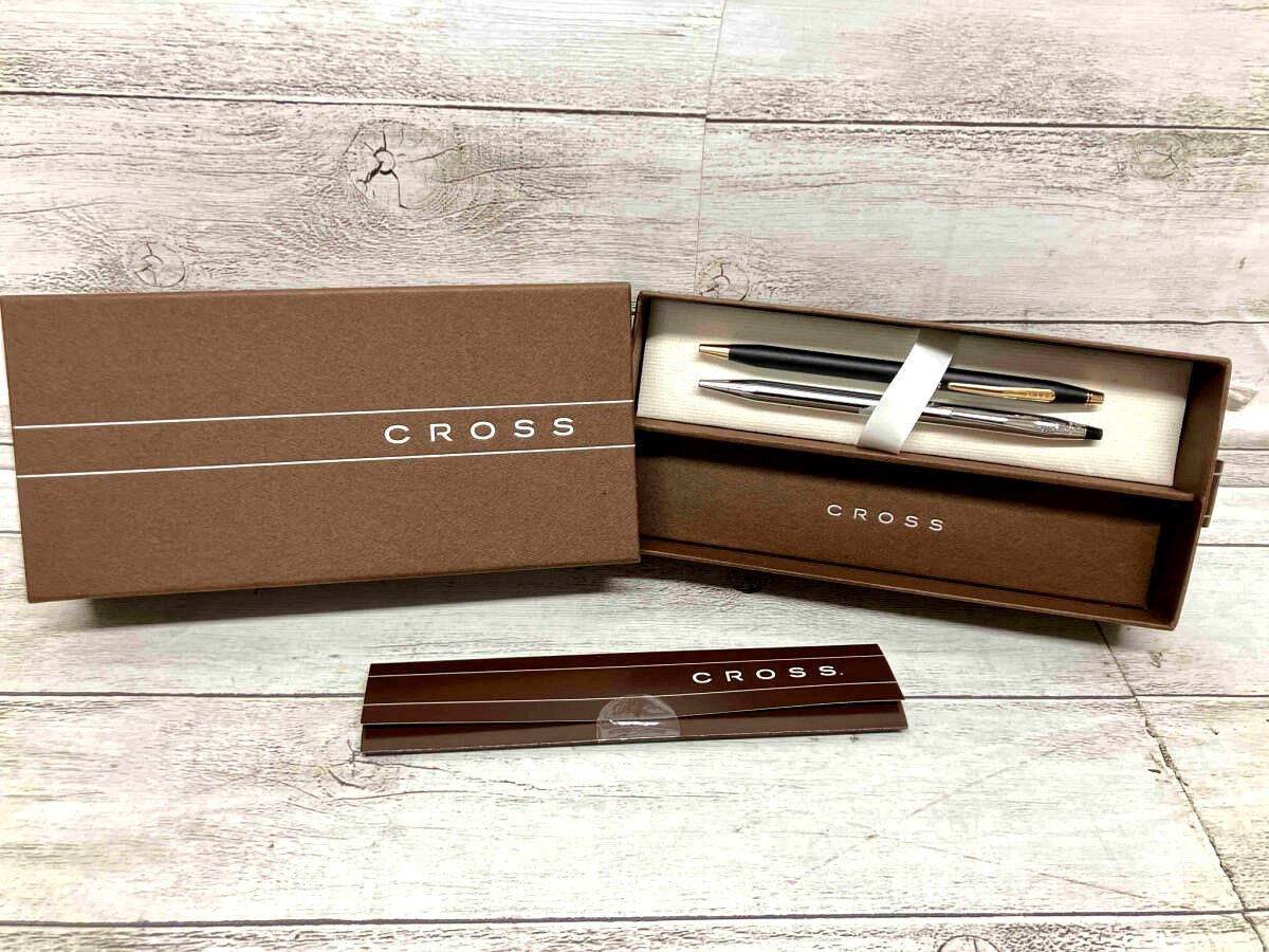 Two Cross black and silver twist ballpoint pens side by side