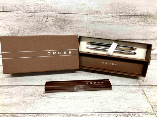 Two Cross black and silver twist ballpoint pens side by side